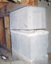 Concrete crawl space support posts in Pickering that are showing signs of failure as they sink into the earth.
