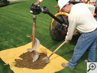 Auguring a hole in the earth for a foundation repair in Owen Sound