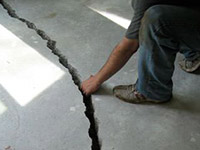 a severely damaged cracked concrete slab floor in Newmarket