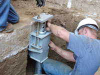 Foundation repair contractors installing the foundation bracket in Brampton.