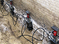 Using foundation push piers to lift a foundation during a repair in Oshawa.