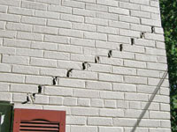 Stair-step cracks showing in a home foundation in Caledon