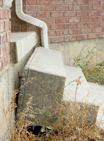 sinking outdoor concrete steps showing cracking and soil washout in Newmarket