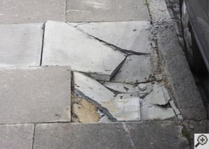 photo of a sinking concrete sidewalk with cracks in Caledon