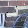 A closeup of a failed tuckpointing job where the brick cracked on a Orangeville home.