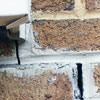 Failed crack repair showing old tuckpointing that cracked on a Brampton home.
