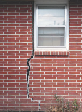 severe foundation wall cracks along a window in Aurora