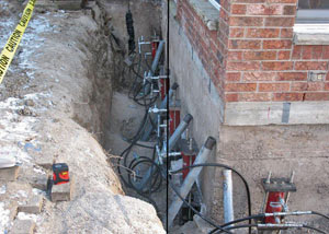 Foundation push piers installed around a house with a foundation settlement issues in Orillia