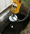 Installing a helical pier during a foundation repair in Hamilton