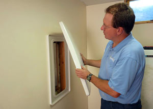Foundation wall anchor covers installed in a finished basement with a repaired foundation wall in Orillia.