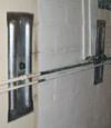 Foundation wall anchor plates installed in a basement in Brampton