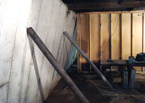 A severely tilting foundation wall propped up by steel beams in Orangeville.