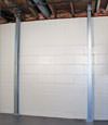 A steel i-beam system installed on a Orangeville foundation wall