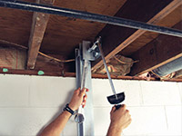 Straightening a foundation wall with the PowerBrace™ i-beam system in a Oshawa home.