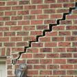 stair step cracking reaching from a window along the foundation wall in Brampton