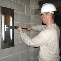 installing a wall anchor to repair an bowing foundation wall in Oshawa
