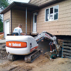Excavating to expose the foundation walls and footings for a replacement job in Barrie