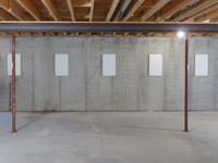 A repaired basement wall with foundation wall anchor covers installed in Oakville.