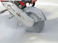 Cutting the driveway for expansion joints during street creep repair in Ajax