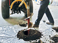 Digging the hole used for wall anchor installation in Peterborough.
