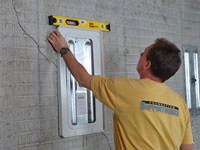 Positioning a wall plate cover on a foundation wall in Richmond Hill.