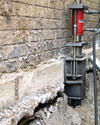 A completed installation of foundation push piers lifting a foundation in Ajax