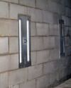 an inside view of foundation wall anchors installed along a basement wall to brace and repair the structure in Whitby